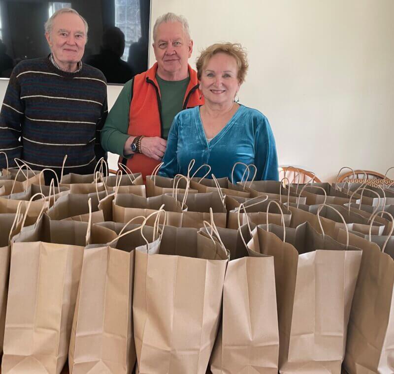 Photo by Lori YorkFrom left, Frank Califano, Sean Moran and Carol Pepin help with Grab-and-Go meals. Volunteers distribute between 70-120 meals on Thursday mornings.