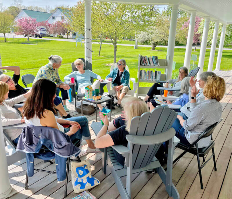 Courtesy photo The weather has been wonderful for book chats on the library porch on Wednesday afternoons.
