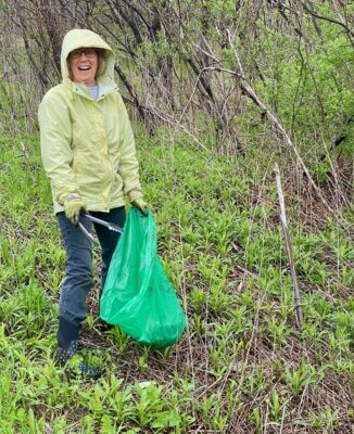 Photo by John Quinney Colleen Armstrong picking up trash on Spear Street Extension.