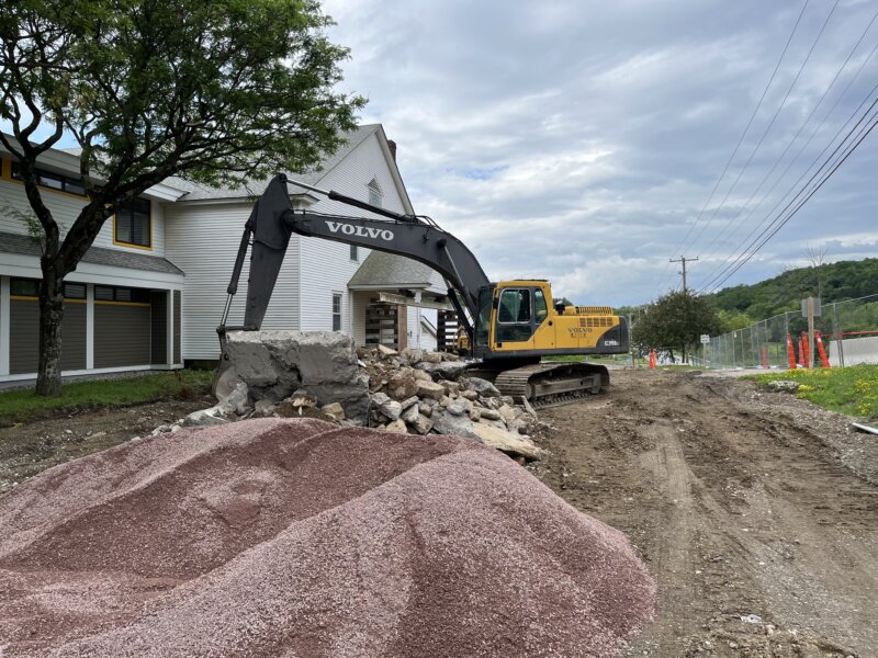 Courtesy photoAn excavator digs up the parking area in front of Charlotte Central School so that five 4000-gallon water tanks that will feed the new fire suppression system can be installed.