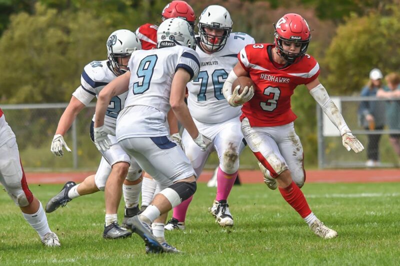 Photo by Al Frey. Anderson McEnaney evades Seawolves tacklers. The junior scored on both offense and defense in Champlain Valley’s 49-0 victory.