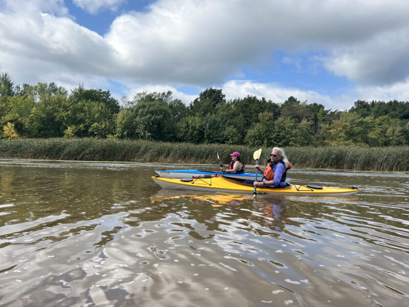 Photo by Susan Hyde. Joan Mollica enjoyed the great weather for the August Women’s Kayak Trip to South Slang Little Otter Creek.
