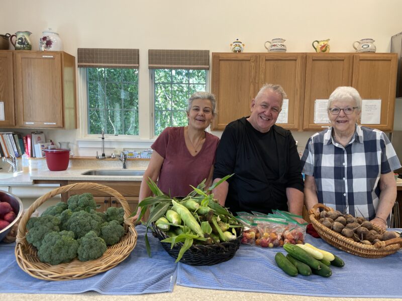 Photo by Lori York. From left, Cheryl Sloan, Sean Moran and Ruth Whitaker stand with some of the produce from Full Moon Farm that is given away weekly at the senior center to those who are over 60 years old as part of the Locally Yours program.
