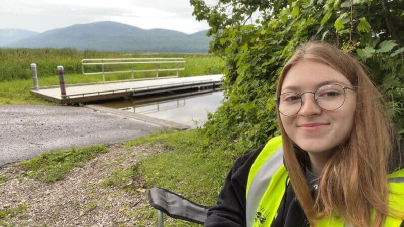 Courtesy photo
Portia Butrym, one of the boat launch stewards for summer 2023, waits for visitors at Bristol Pond on an overcast July morning.