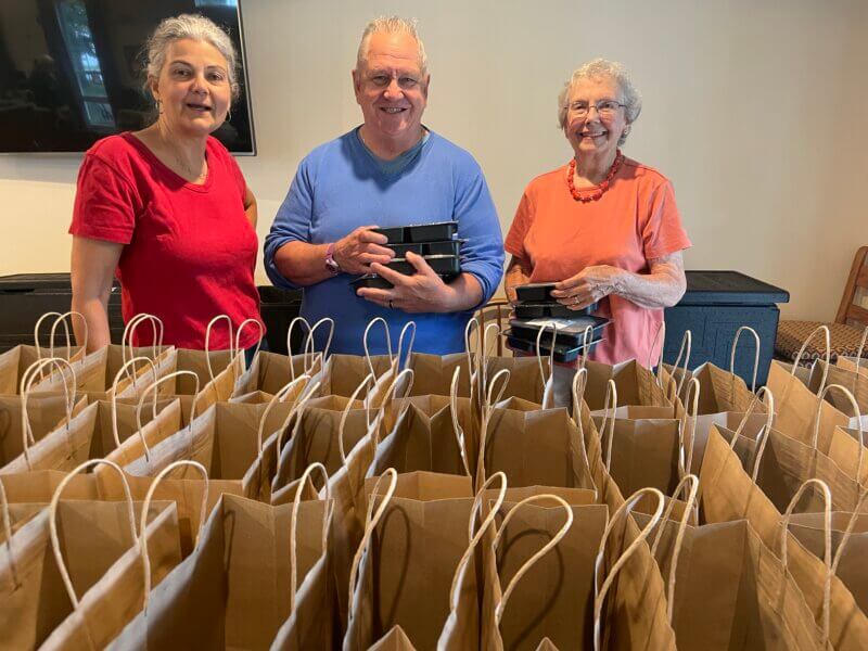 Photo by Lori York
From left, volunteers Cheryl Sloan, Sean Moran and Roberta Whitmore distribute Age Well weekly grab & go meals on Thursday mornings.