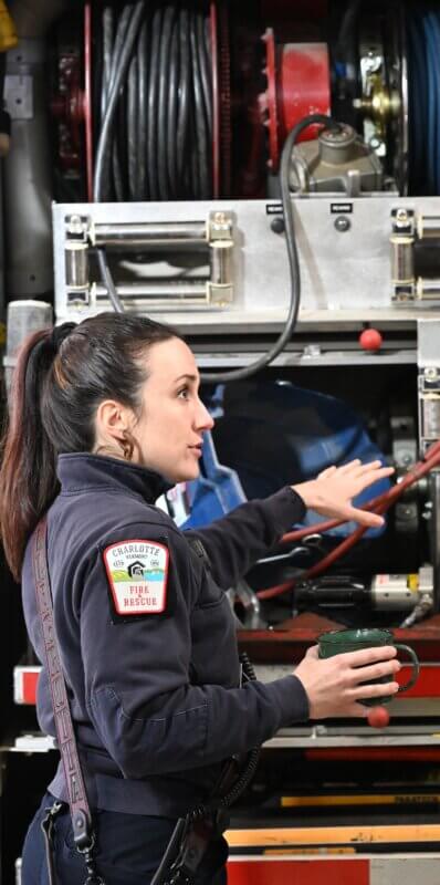 Photo by Lee Krohn. Open House Medical duty crew and training officer Kay Della Grotta demonstrates heavy rescue hydraulic extrication equipment at Saturday’s open house.