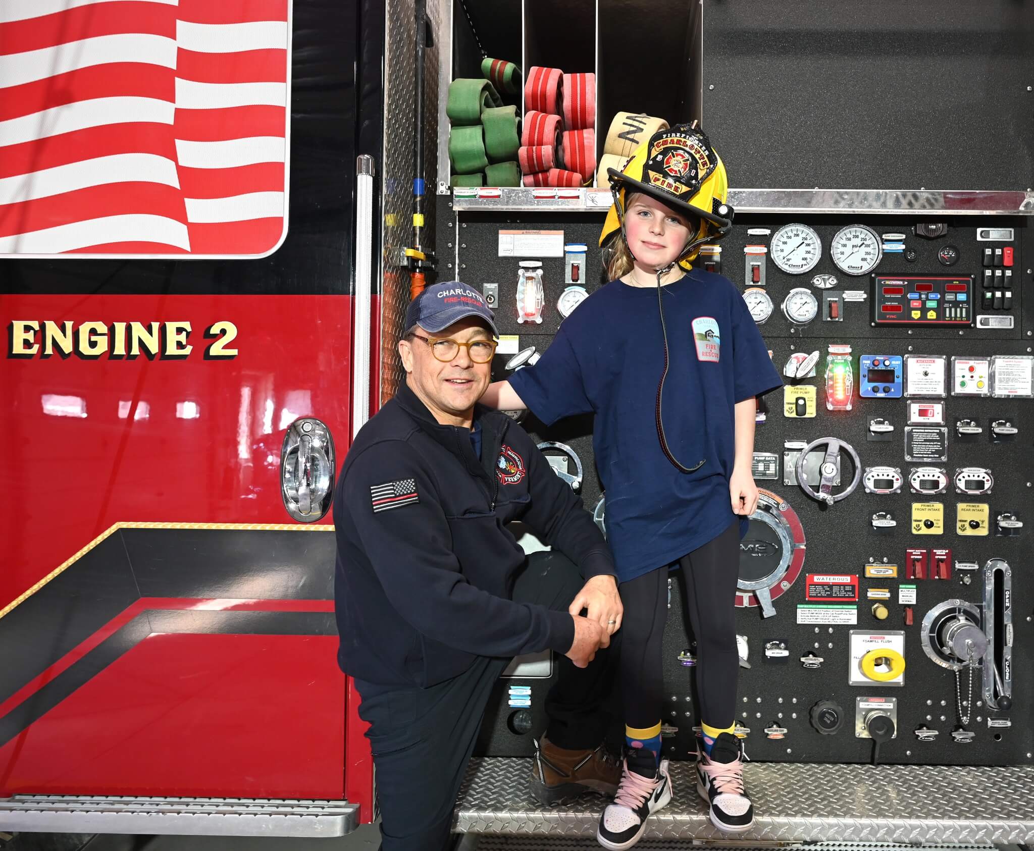 Photo by Lee Krohn.
Carter models a fire helmet for her father Robert Caldwell at the Charlotte Volunteer Fire and Rescue Service’s open house 1-4 p.m. last Saturday, Feb. 24.