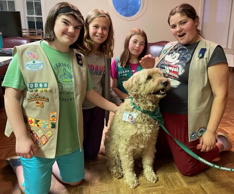Courtesy photo. 
From left, Jenny Blanshine, Colbie Curler, Mia Paquette and Alexis Pearce visit with a service dog while working on their animal badges.