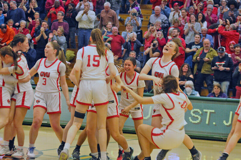 Photo by Scooter MacMillan. 
Players celebrate moments after winning their second state basketball title in a row over St. Johnsbury.