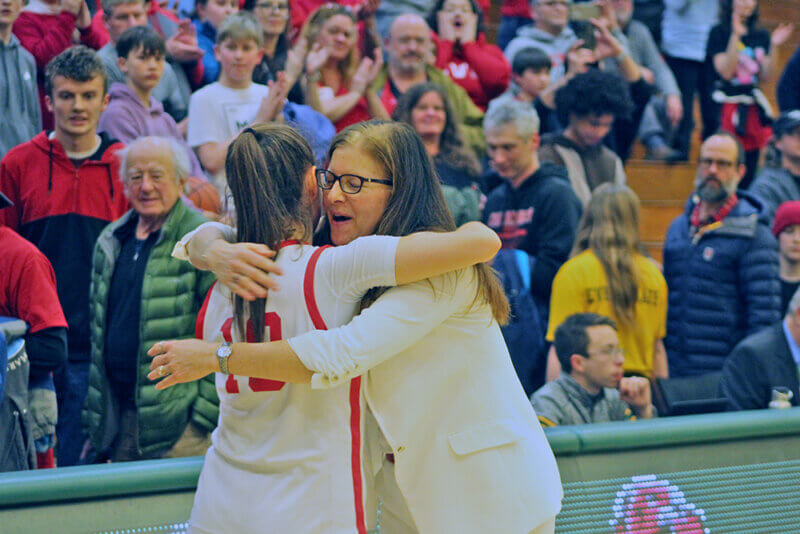Photo by Scooter MacMillan. 
Senior Nina Zimakas and coach Ute Otley revel in the thrill of the state championship.
