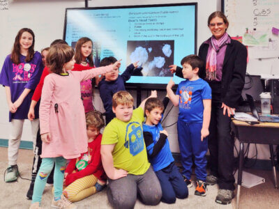 Photo courtesy. Michelle Bos-Lun Students from Windham Elementary School and Compass Middle School point to the bear’s head tooth on the day of their decision.