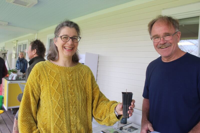 Susan Blood hands Peter Demick a seedling from the oldest living sycamore in Connecticut, which he will plant on his property. Both are members of the Charlotte Conservation Commission.