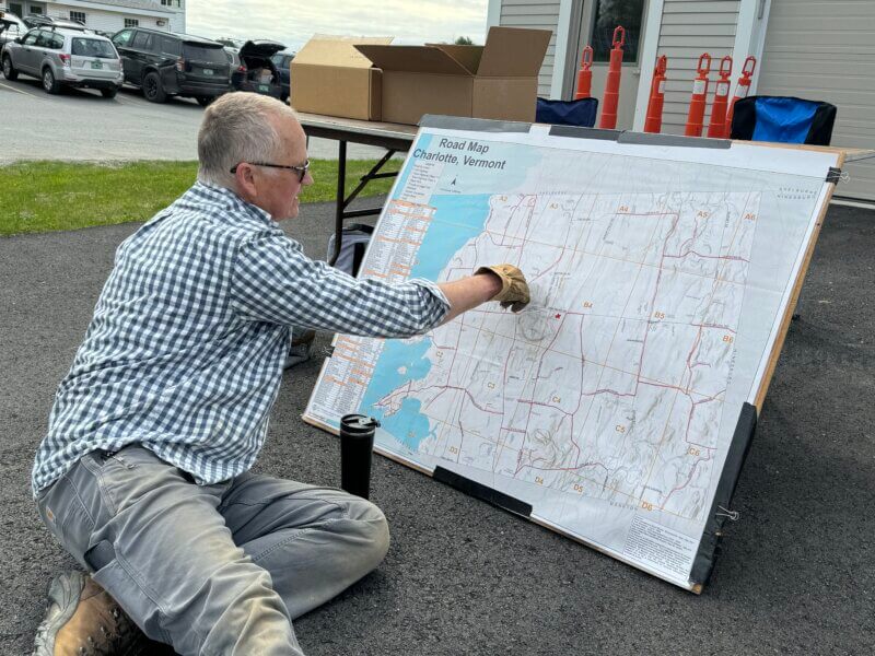 Photo by Scooter MacMillan. Ken Spencer marks off the roads that have people committed to cleaning them up.