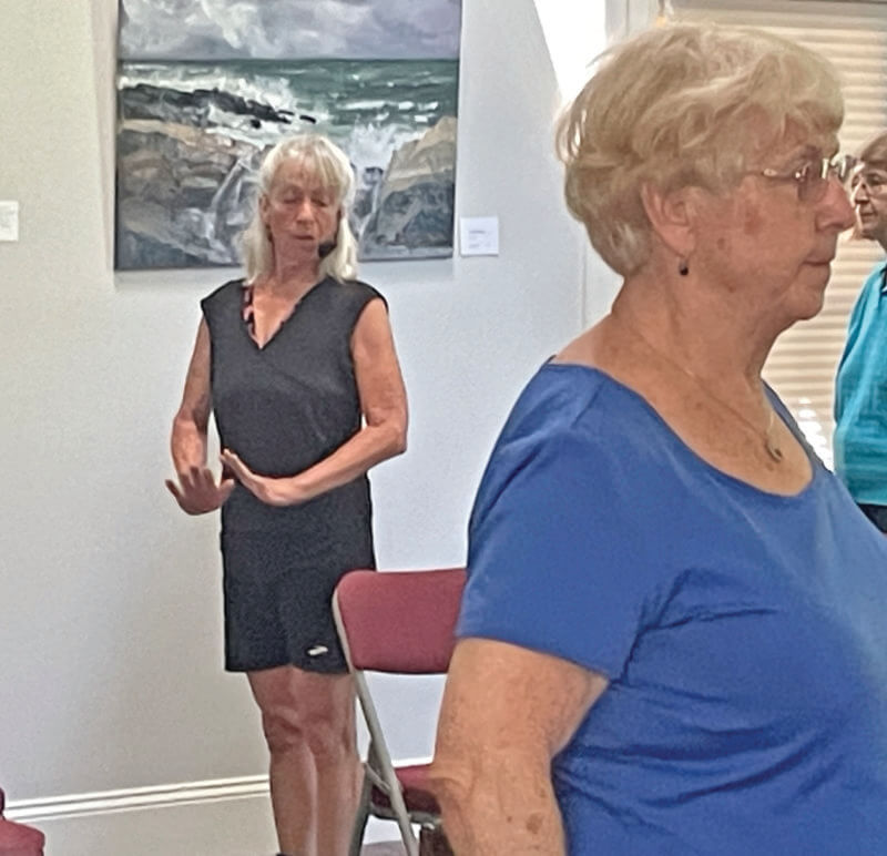 Photo by Lori York.
Yoga instructor Heidi Kvasnak leads a yoga class at the senior center with the new headset and sound system.