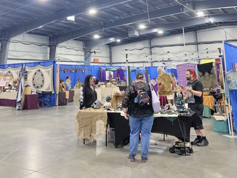 Photo by Camryn Brauns.
Attendees around a table at the Vermont Psychic Expo, Aug. 9-10, in Essex. 
