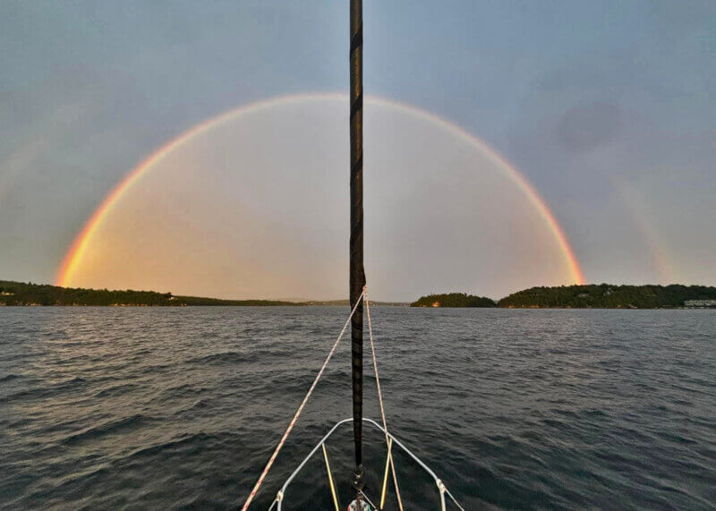 Photo by Julie Trottier. 
On the way back to Malletts Bay on Aug. 11, after the Diamond Island Regatta and Split Rock Race, Julie Trottier on Meridian sailed right into the middle of a rainbow.
