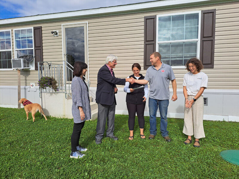 Courtesy photo. From left, Patti Komline, vice chair of the Vermont Disaster Recovery Fund, treasurer Mike Yantachka and Sofia Benito Alston of Champlain Valley Office of Economic Opportunity deliver a $21,000 check to Alex and Addie Wheeler for the loss of their Berlin home in the July flooding. The Wheelers have a new home in East Montpelier.