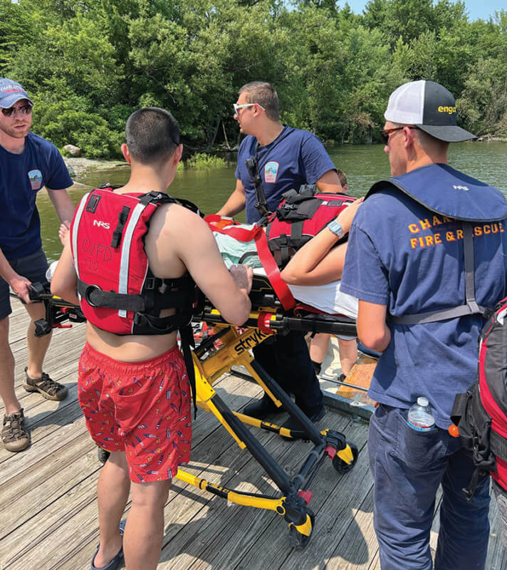 Courtesy photo. Rescue workers practice getting Libby Manning into a gurney from the fire and rescue boat and to an emergency vehicle at the Converse Bay Fish and Wildlife lake access point.