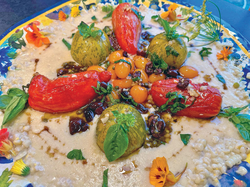 Photo by Dorothy Grover-Read. Roasted tomatoes over polenta combines two of our favorite late-summer crops. You can use whatever tomato you love to adorn this creamy polenta, which bursts with extra corn flavor.