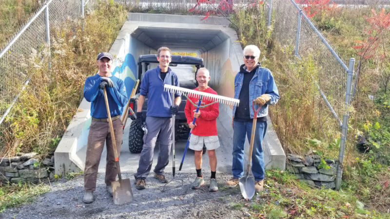 Photo by John Limanek. From left, trails committee members Chris Boffa, David Ziegelman, Jack Pilla and Richard Hendrickson pose after working on the Town Link Trail by the Route 7 underpass.
