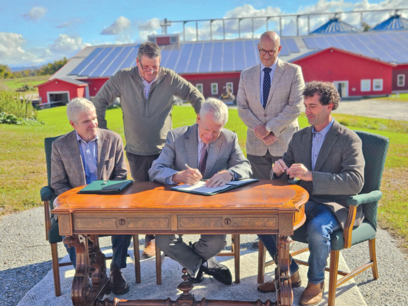 Photo by Joshua Defibaugh/University of Vermont
Front from left, Christian Peters of the USDA, Richard Cate of the University of Vermont and Nordic farm owner Ben Dobson sign an agreement for the farm to lease around 400 acres for agricultural research, while Vermont Agriculture Secretary Anson Tebbetts and UVM Vice President for Research Kirk Dombrowski watch the historic agreement.
