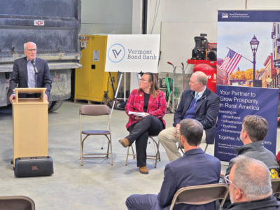 Photo by Mike Yantachka From left, Sen. Peter Welch, Sarah Waring of the U.S. Department of Agriculture and Ted Brady, executive director of the Vermont League of Cities and Towns celebrate Charlotte’s piloting of loan program in funding for town garage solar power panels.