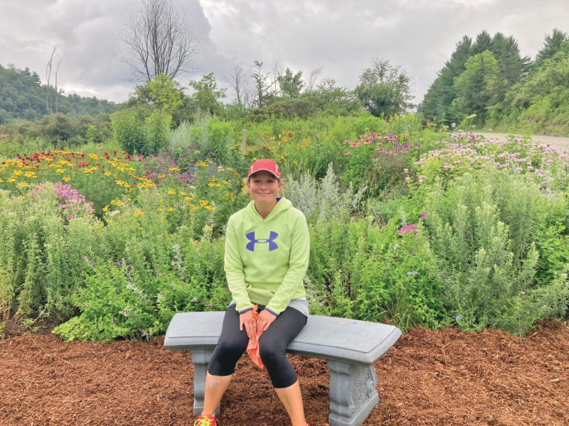 Photo by Josh Dickinson.
Julia Parker-Dickinson enjoying the butterfly garden at the Quinlan Covered Bridge.