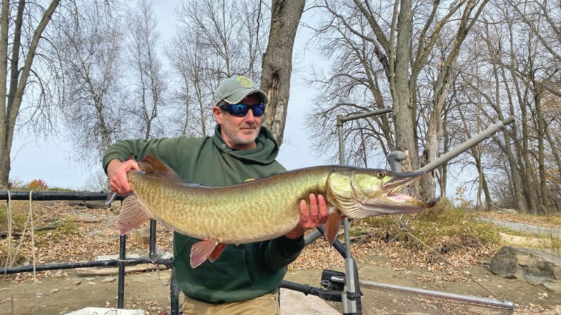 Photo by Kate Kampner.
Shawn Good holds up the sixth and final muskie to be tagged that October day.