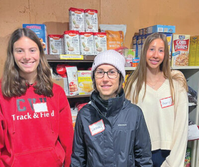 Courtesy photo From left, Cece Scriber, Lindsay Landrigan and Avery Siket enjoying volunteering at Charlotte Food Shelf as a way of connecting with the community.