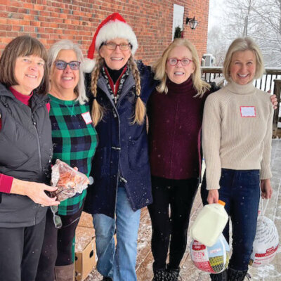 Photo courtesy of Margaret Sharpe. Snowy, blustery weather did not slow down, from left, Peggy Sharpe, Maria Blanchette, Laura Iglehart, Nancy Bloch and Janet Landrigan in their early morning preparation for the holiday food shelf distribution on Dec. 21.