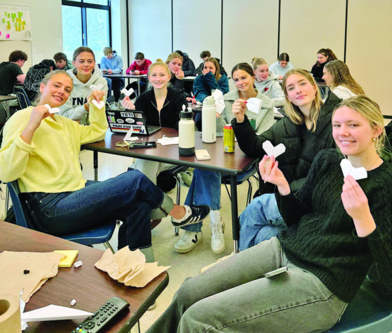 Photo by Lila Webster.
Students from the Champlain Valley High Senior Service Club practice origami hearts in preparation for the craft night they will be hosting at the Charlotte Senior Center