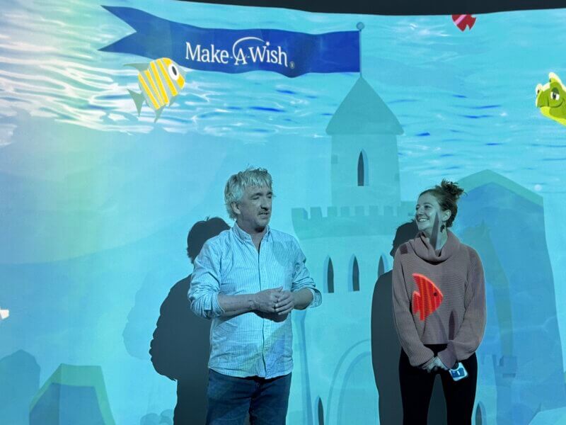 Photo by Scooter MacMillan.
Make-A-Wish CEO Jamie Hathaway, left, introduces Wish Kids to the new Discovery Theater as wish manager Jamie Heath prepares to discuss her children’s book “Wishes Are Medicine,” featured in the animated film telling the story of her recovery from a serious illness when she was a teenager with help from the organization.