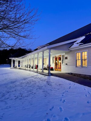 Photo by Meg Berlin The library light glows on the snow at night.
