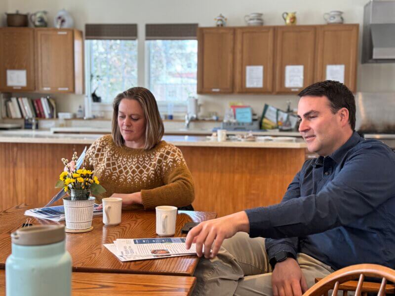 Meghan Metzler, chair of the Champlain Valley School District board, and Tim O’Leary, lead principal at Charlotte Central School, speaking about the district’s proposed budget for fiscal year 2026 to a group of residents at the senior center.