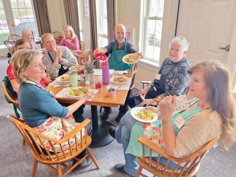 A group of volunteers from the Monday Munch cooking team, enjoying the meal they’ve just prepared.