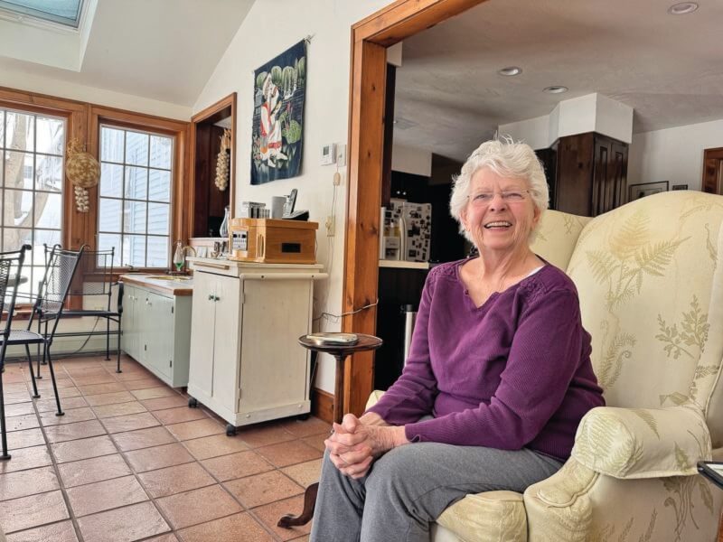 Photos by Scooter MacMillan. Gardening and cooking columnist Joan Weed sits in her garden room, so called because it’s filled with windows looking out onto the garden, the source of much of the inspiration for her regular column in The Charlotte News.