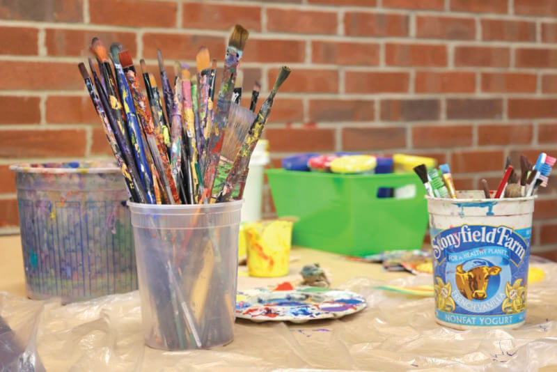 Photo by Catherine Morrissey.
Paints and brushes ready to be used at Winooski School District.