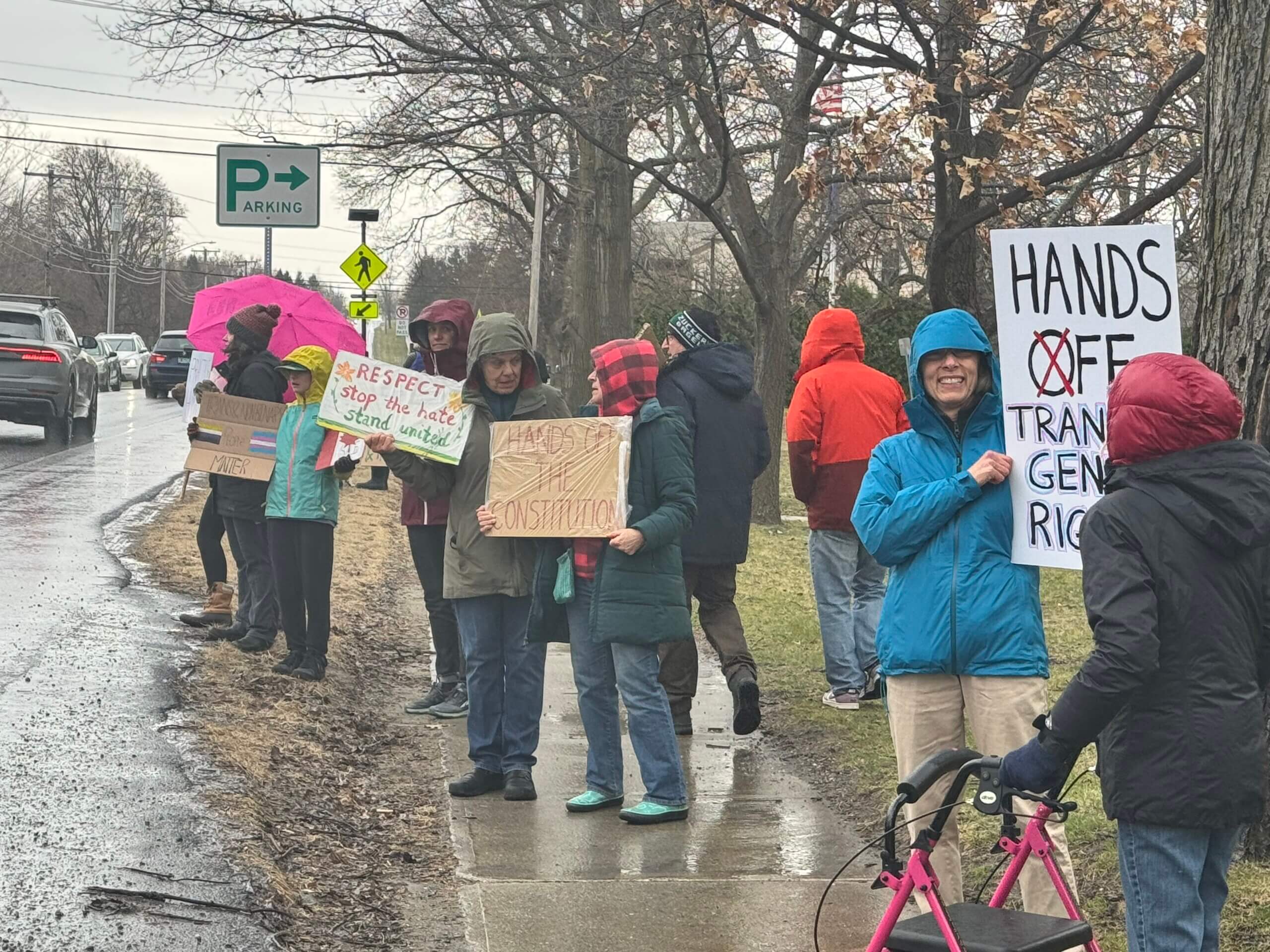 Photo by Scooter MacMillan.
The rain and cold didn’t seem to dampen the spirits of protesters or diminish their ire.