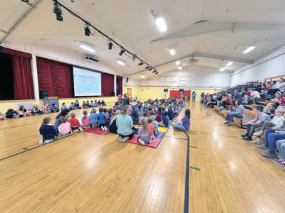 Courtesy photo. Students gather to read books that connect with Charlotte Central School’s mission of taking care of ourselves, others and this place.