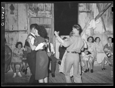 Photo courtesy Library of Congress. People dancing in a barn in Louisiana in 1938, as shown in a film negative from Farm Security Administration photographer Russell Lee.