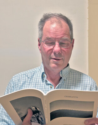 Photo by Julia Russell. Charles Russell reviewing the Town Report.