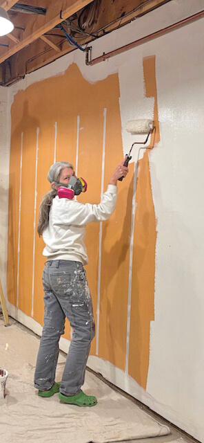 Photos by Peggy Sharpe.
Carrie Fenn helping to transform the food shelf space.