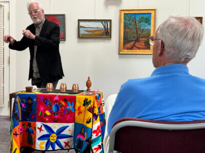 Photo by Scooter MacMillan. You might say that Hank Kaestner was spellbound by Tom Verner’s demonstration of the ancient cups and balls magic trick.