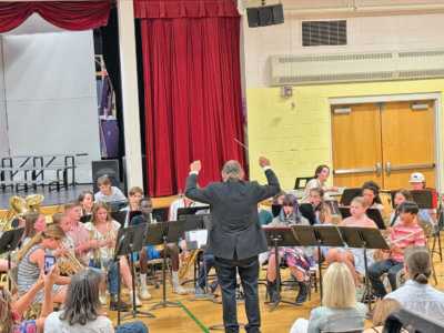 Photo by Elizabeth Hunt. Charlotte Central School band teacher Andy Smith conducts the band at its spring concert on May 28.