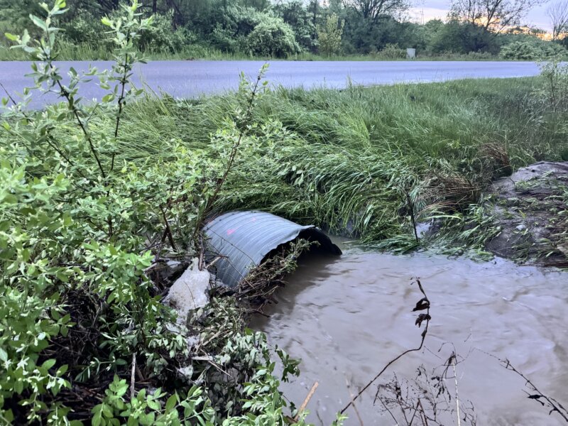 Photo by Scooter MacMillan. Heavy rain on May 17 brought the water out of the culvert and over Greenbush Road just north of the railroad trestle, but it had gone down by the time this photo was taken.