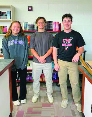 Courtesy photo. From left, seniors Nora Nelson, Dylan Frere and Henry Bushey have been a big help at the Charlotte Food Shelf and are going to be missed next year when they’re away at college.