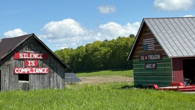 Photo by Steve Goldstein. Peter and Carrie Fenn felt the situation with the current administration is so desperate that they had their feelings painted on their barns.