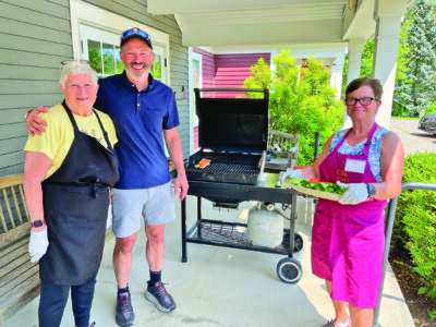 Photo by Lori York The grill was fired up at the Senior Center for Monday lunch, thanks to volunteers Carol Strobeck, her son Matthew and Sue Foley.