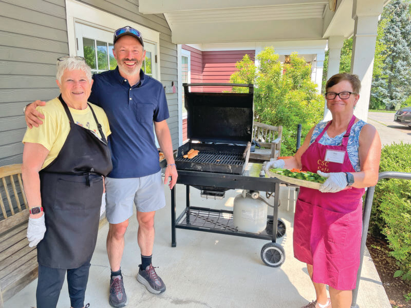 Photo by Lori York The grill was fired up at the Senior Center for Monday lunch, thanks to volunteers Carol Strobeck, her son Matthew and Sue Foley.