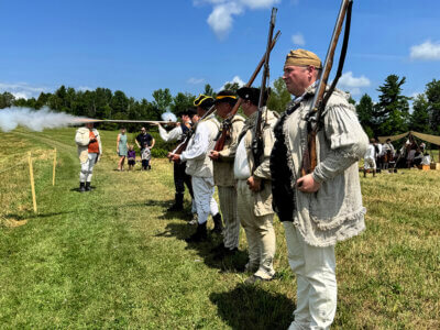 Reenactors participate in a loading and reloading competition to demonstrate the difficulties of fighting with the guns of the day.